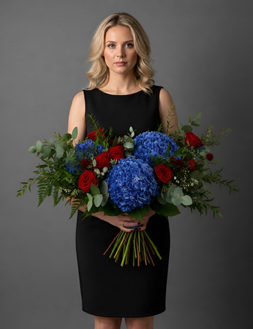 The Garden Breeze bouquet features blue hydrangeas, Naomi roses, eucalyptus and ferns.