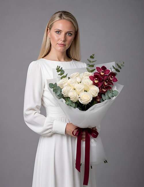 The Orchid Obsession bouquet features Avalanche roses, eucalyptus branches and Cymbidium orchids.