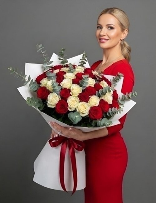 The bouquet As You Like It, contains red roses, white roses and eucalyptus leaves.