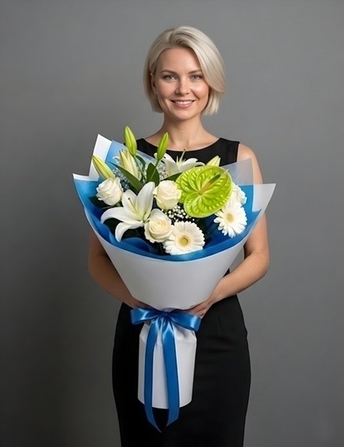 A sculptural 'Graceful Bloom' bouquet featuring white Avalanche roses, exotic anthuriums, white lilies, and pink gerberas enveloped in a cloud of white gypsophila.